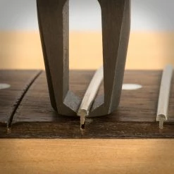 StewMac Precision Fret Puller - StewMac -Strings + Accessories Shop 1636 4 close up pulling 3000px