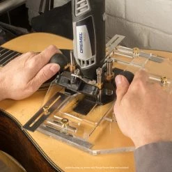 Saddle Routing Jig - StewMac 11 Saddle Routing Jig - StewMac -Strings + Accessories Shop 4043 6 with plunge and hands 3000px